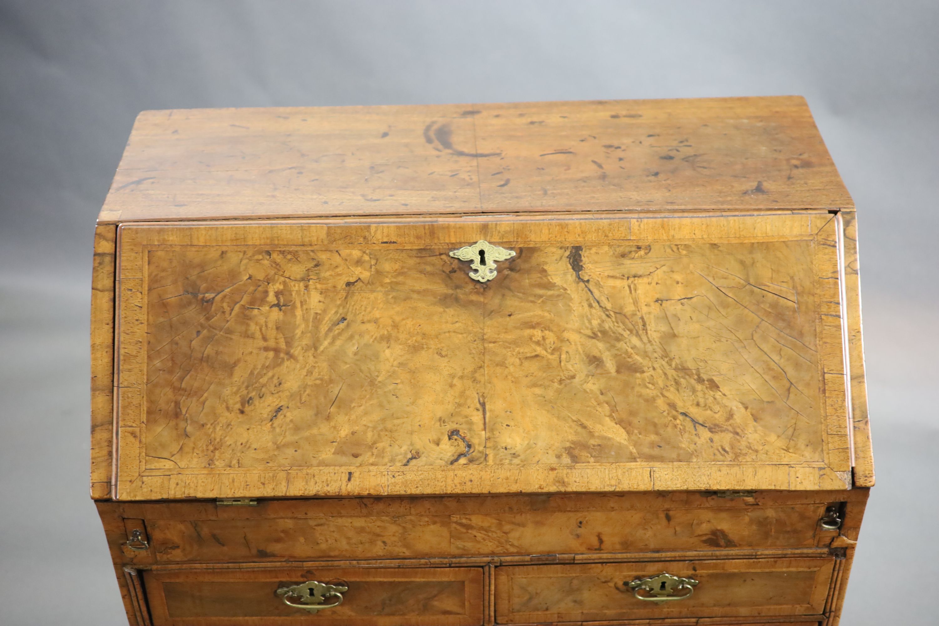 An early 18th century small walnut and crossbanded bureau, width 84cm, depth 46cm, height 98cm